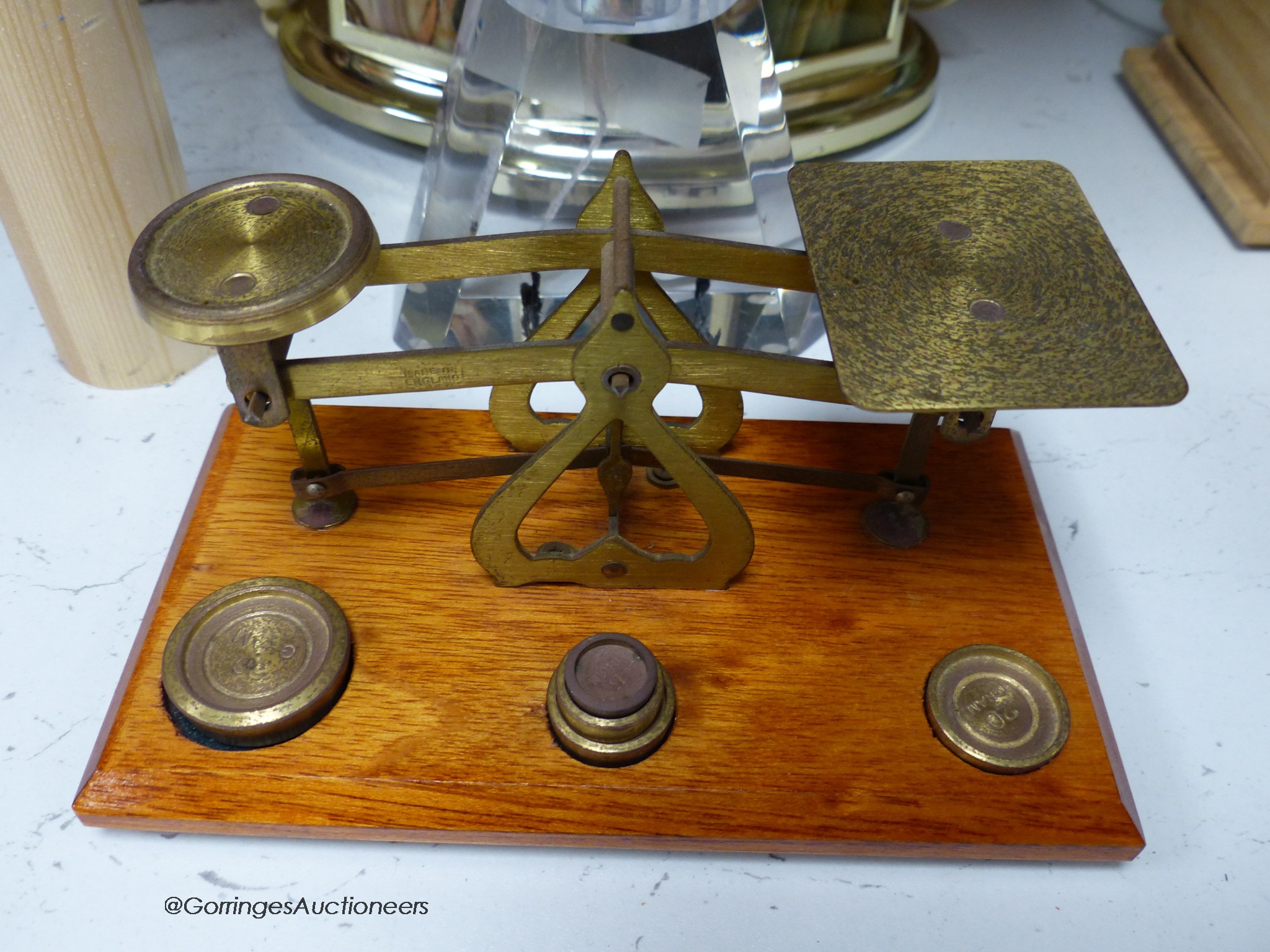 A pair of brass letter scales, a 1960's plastic table top lighter and an onyx telephone